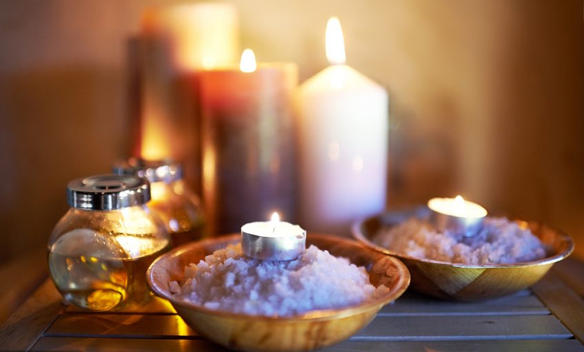 An arrangement of scented candles and oils at a spa